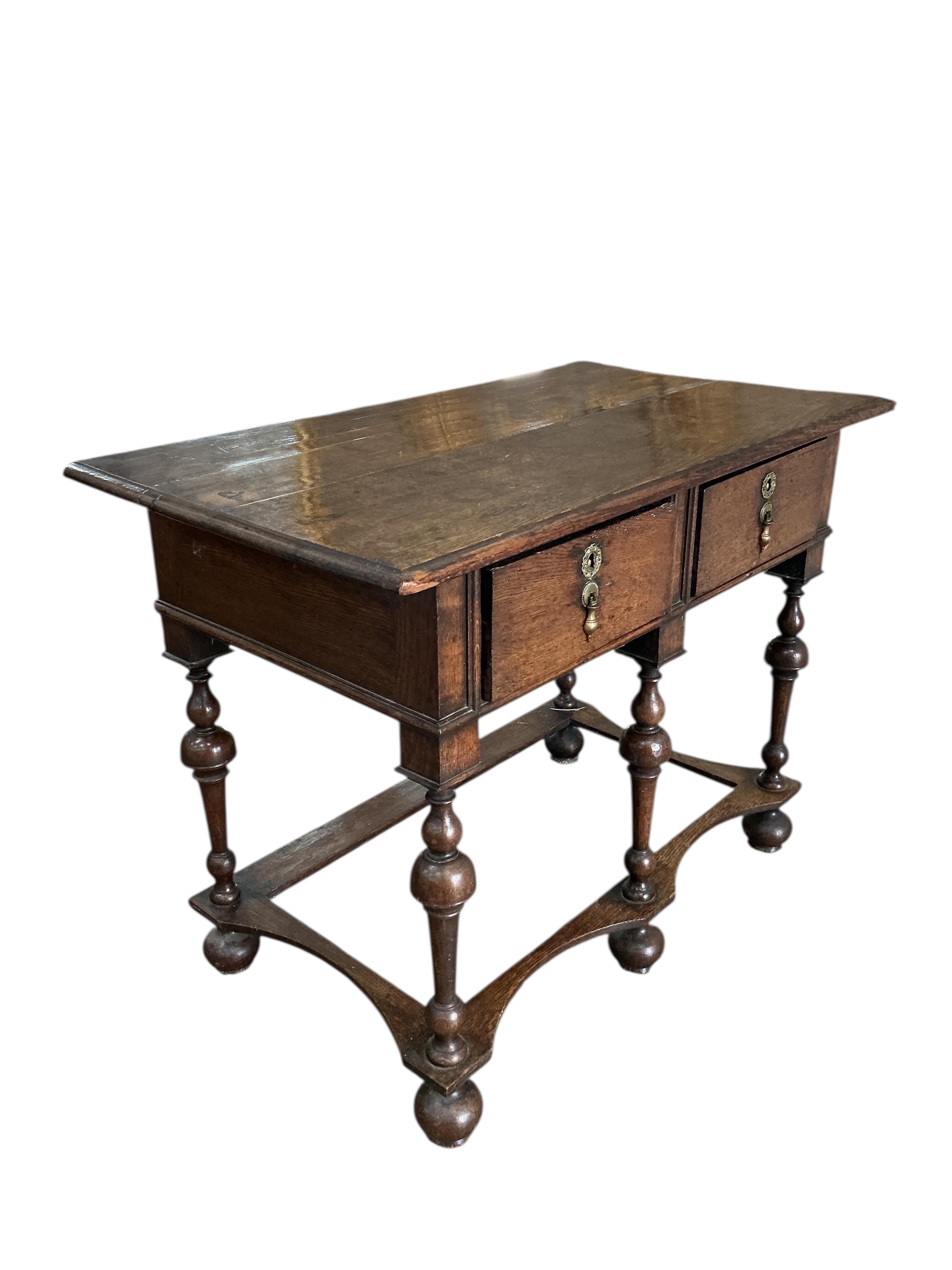 A William and Mary style oak two drawer side table, width 96cm, depth 54cm, height 72cm